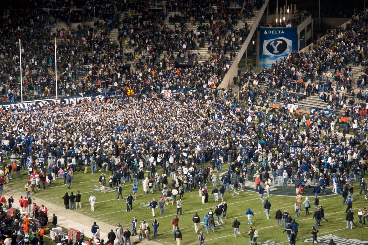 Fans rush the field at LaVell Edwards Stadium in Provo after BYU beat Utah 26-23 in overtime on Nov
