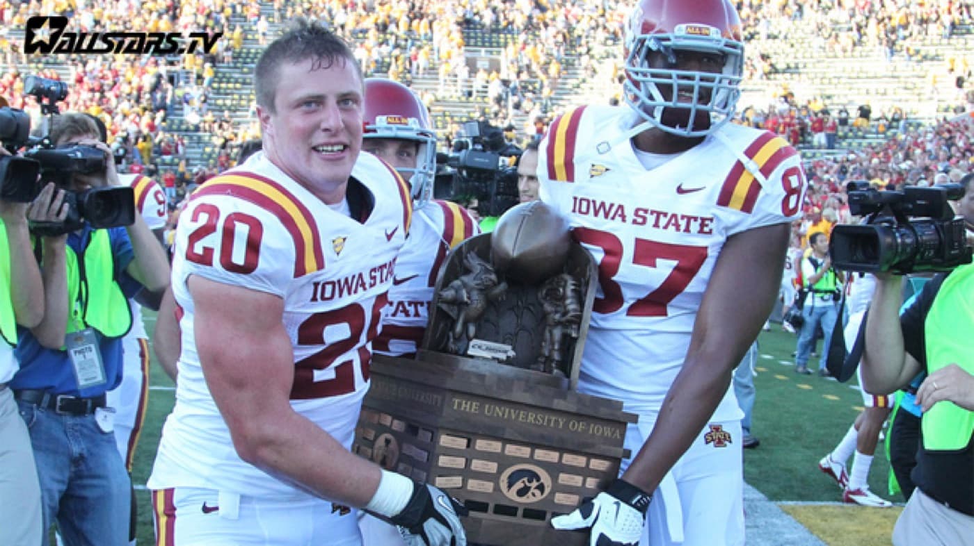 Iowa State players Jake Knott, Jeff Woody and David Irving carry the Cy-Hawk Trophy off the field after Iowa State's win at Kinnick Stadium on Sept