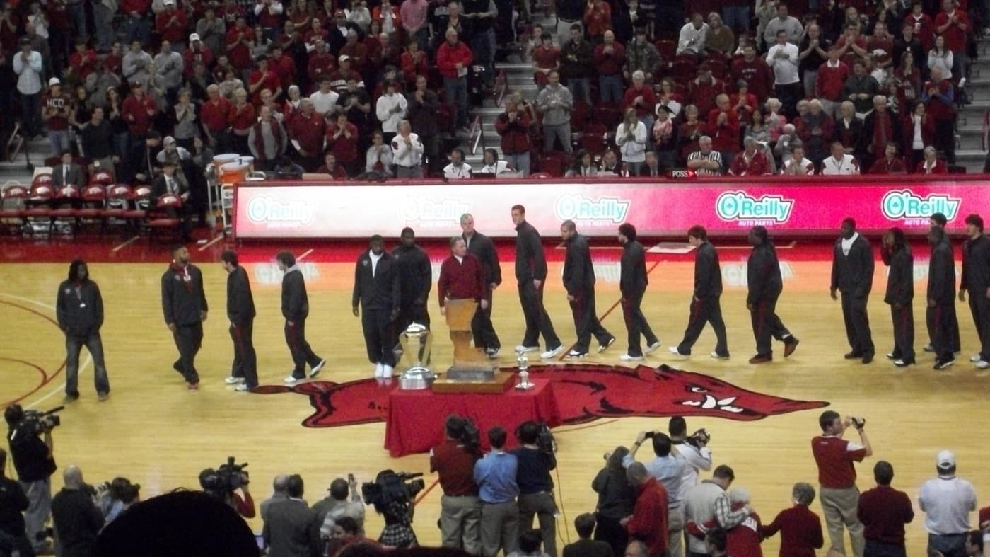 Arkansas football players and coach Bobby Petrino at a halftime ceremony during a men's basketball game in Fayetteville in January 2011, celebrating the 2010 win over LSU