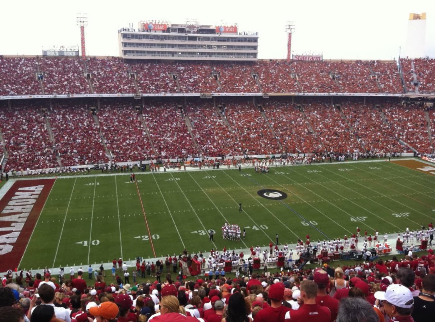 The 2012 Red River Rivalry game at the Cotton Bowl in Dallas, seen from the stands with the crowd split between Oklahoma crimson and Texas burnt orange