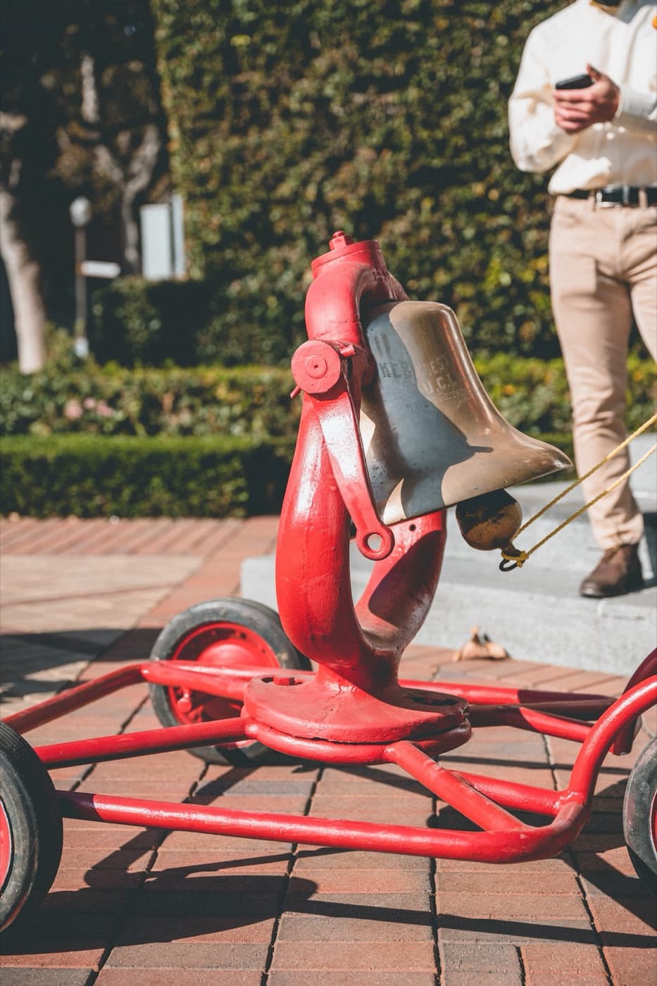 The Victory Bell with its carriage painted cardinal during USC possession, with a Trojan Knight escorting it