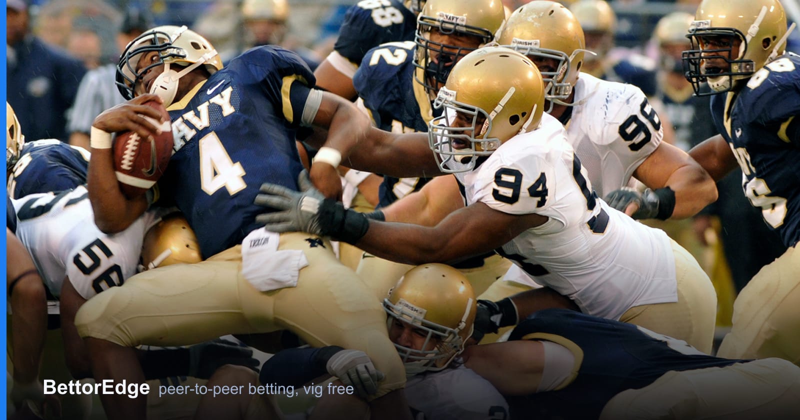 A college football running back diving over the pile for short yardage, the kind of play that decides a spread